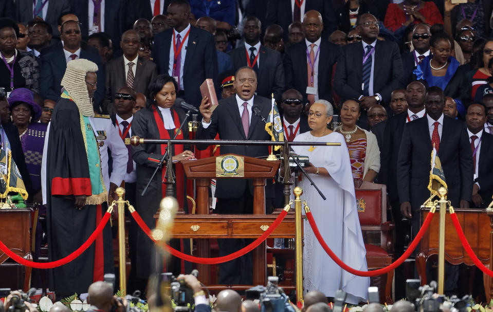 <p>Kenyan President Uhuru Kenyatta, center, is sworn-in, accompanied by his wife Margaret, center-right, at his inauguration ceremony at Kasarani stadium in Nairobi, Kenya Tuesday, Nov. 28, 2017. (Photo: Ben Curtis/AP) </p>