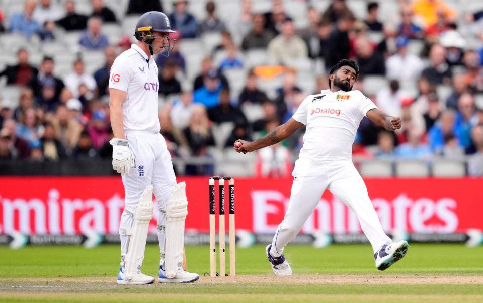 Sri Lanka's Asitha Fernando (right) bowling as England's Dan Lawrence looks on during day two of the First Rothesay Test match at the Emirates Old Trafford