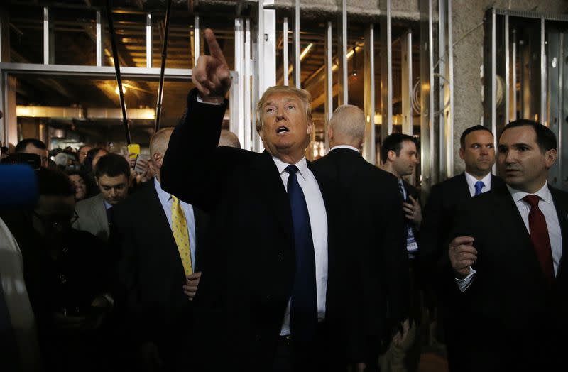 Republican U.S. presidential candidate Trump points out features of the building as he leads the news media on a tour of the construction site of the Trump International Hotel in Washington