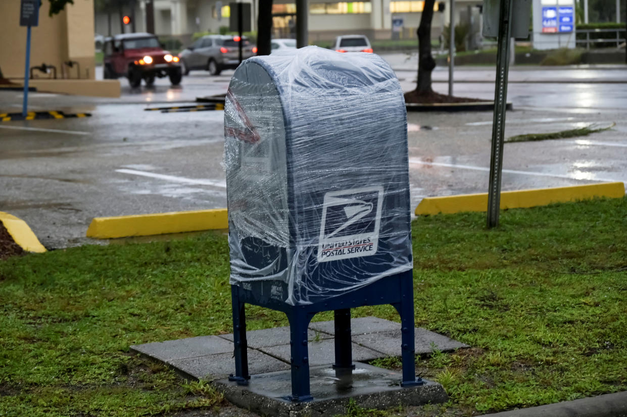 A U.S. postal service mailbox is dry wrapped as Hurricane Ian approaches Florida's Gulf Coast