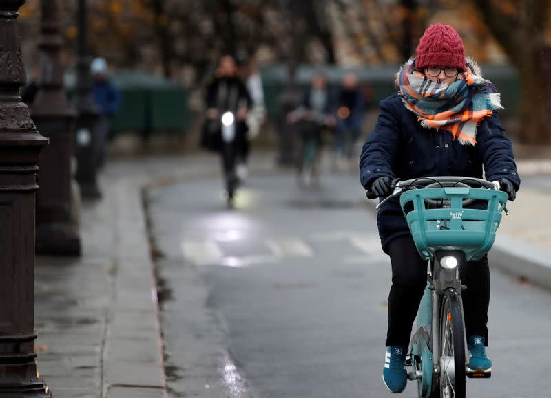 Person rides bicycle during rush hour as a strike by all unions of the Paris transport network (RATP) and French SNCF workers entered its seventh consecutive day in Paris