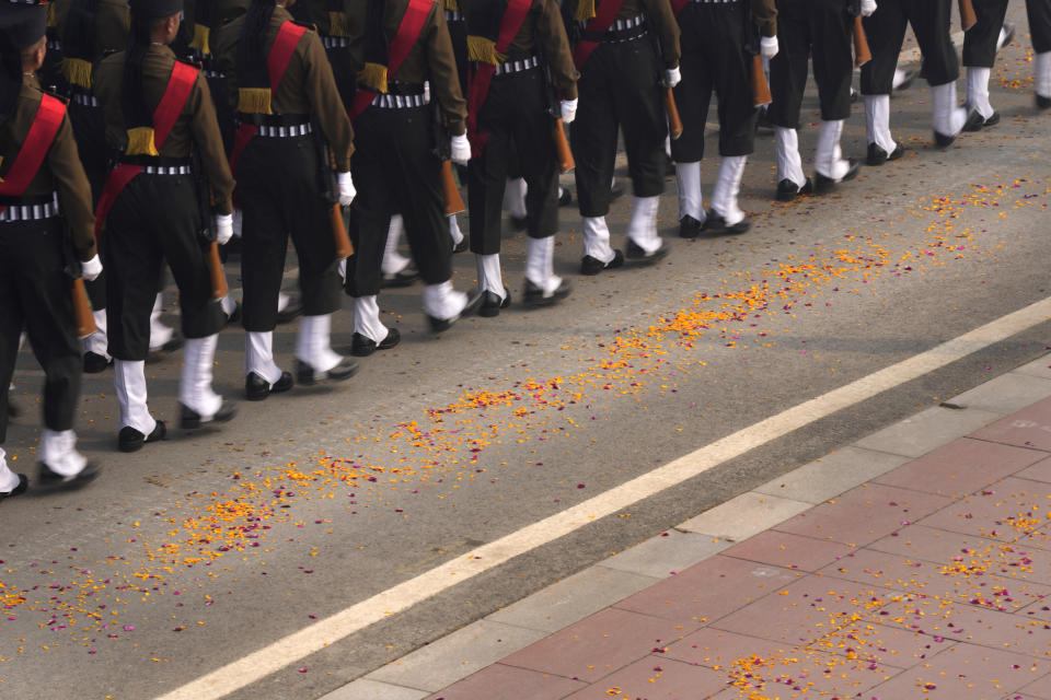 Flower petals showered by helicopters lie on the road as Indian defense forces march on the ceremonial street Kartavyapath during India's Republic Day parade celebrations in New Delhi, India, Friday, Jan. 26, 2024. (AP Photo/Manish Swarup)