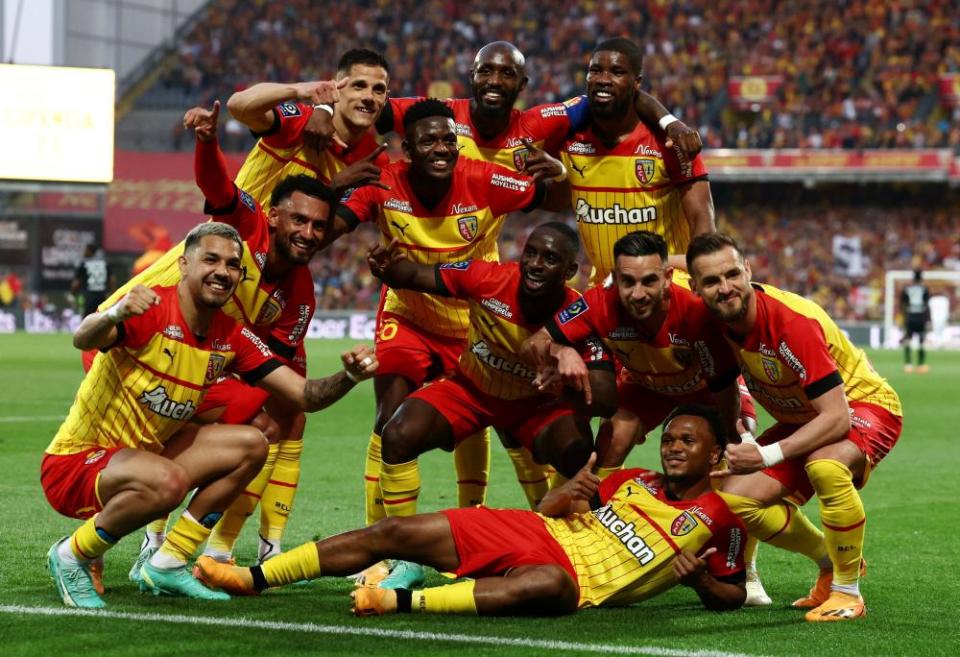 Loïs Openda (on ground) celebrates his teammates after scoring Lens’ final goal in their 3-0 victory over Ajaccio, which secured the team’s spot in next season’s Champions League.