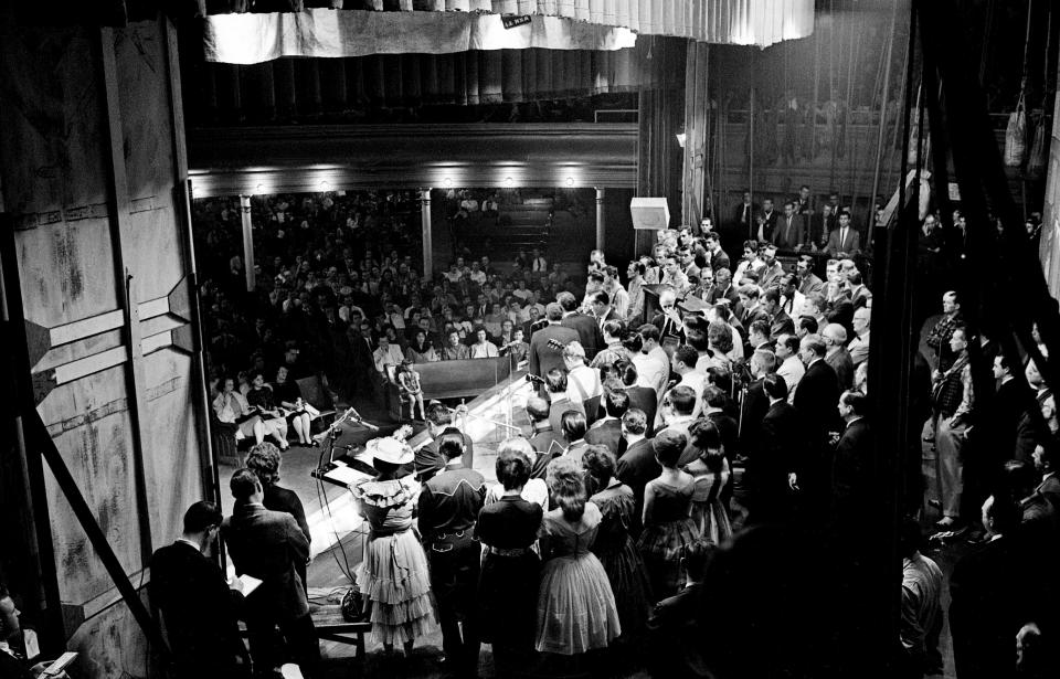 The Ryman Auditorium's stage is filled up as the Grand Ole Opry family paid a simple, solemn tribute March 9, 1963 to the memory of the five killed in accidents the past week, Patsy Cline, Hawkshaw Hawkins, Cowboy Copas, Randy Hughes and Jack Anglin.