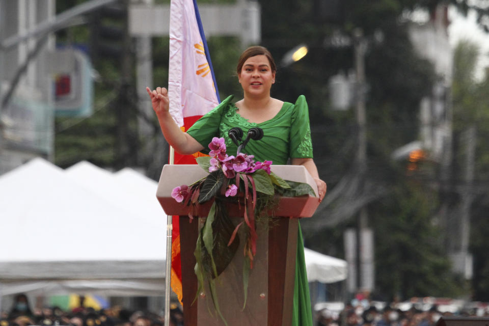 Philippine Vice President-elect Sara Duterte, daughter of outgoing populist president of the Philippines, delivers her speech during her oath-taking rites in her hometown in Davao city, southern Philippines, Sunday, June 19, 2022. Duterte clinched a landslide electoral victory despite her fatherÅfs human rights record that saw thousands of drug suspects gunned down. Also in photo are, from left, Supreme Court Justice Ramon Paul Hernando, her mother Elizabeth Zimmerman and Philippine President Rodrigo Duterte. (AP Photo/Manman Dejeto)