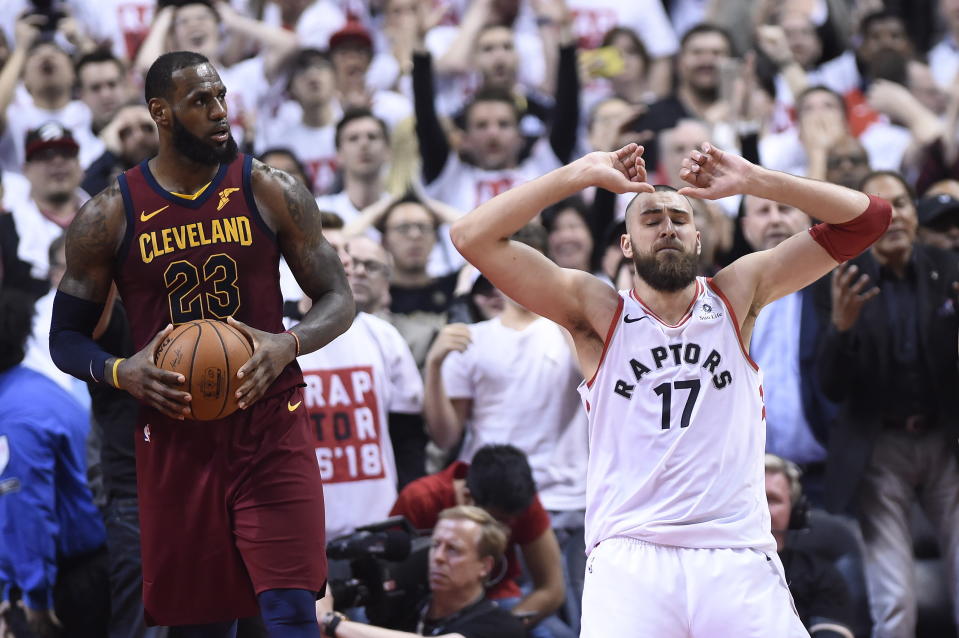 Jonas Valanciunas (right) reacts after missing a shot late in the fourth quarter, giving LeBron James and the Cavs a chance to come back from an early deficit. (Nathan Denette/The Canadian Press via AP)