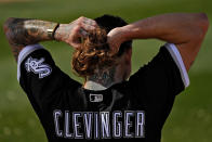 Chicago White Sox pitcher Mike Clevinger pulls his hair back during an MLB spring training baseball practice, Saturday, Feb. 18, 2023, in Phoenix. (AP Photo/Matt York)