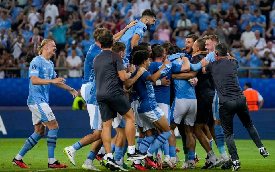 Manchester City players celebrate winning the Super Cup