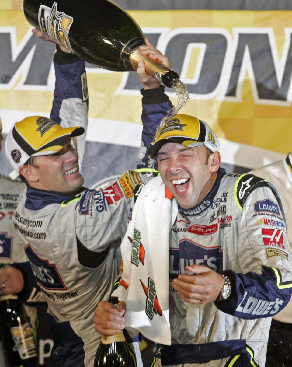 FILE - In this Nov. 18, 2007, file photo, Jimmie Johnson, left, pours champagne on crew chief Chad Knaus as they celebrate after winning the NASCAR Nextel Cup Series championship in Homestead, Fla. Chad Knaus will move off the pit stand and into a management role with Hendrick Motorsports, ending his crew chief career after seven championships. Hendrick on Tuesday, Sept. 29, 2020, announced Knaus will move to vice president of competition. (AP Photo/Terry Renna, File)