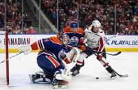 Washington Capitals' Dylan Strome (17) and Edmonton Oilers' Philip Broberg (86) battle for the rebound from goalie Stuart Skinner (74) during the first period of an NHL hockey game in Edmonton, Alberta, Monday, Dec. 5, 2022. (Jason Franson/The Canadian Press via AP)