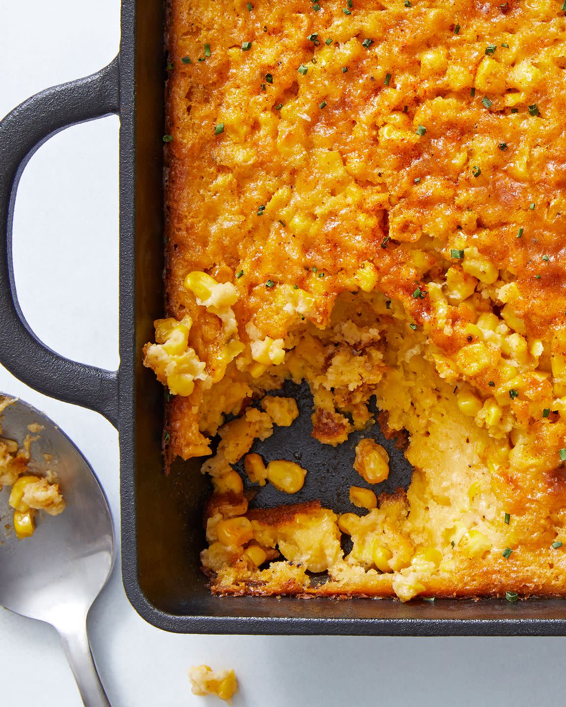 classic midwestern casserole made with jiffy muffin mix, creamed corn, and fresh corn then baked and topped with paprika and chives