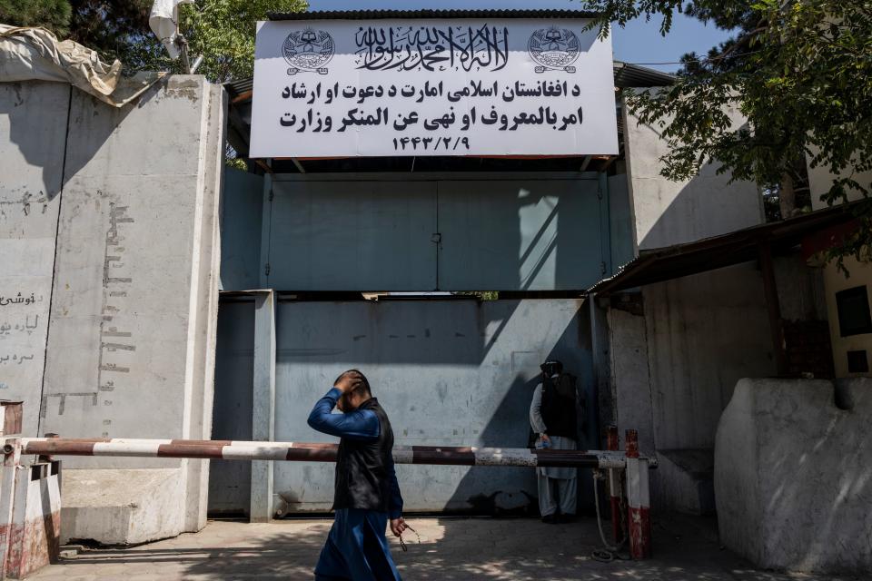 An Afghan man walks past the former Women's Affairs Ministry building in Kabul, Afghanistan, Saturday, Sept. 18, 2021. Afghanistan's new Taliban rulers set up a ministry for the "propagation of virtue and the prevention of vice" in the building that once housed the Women's Affairs Ministry, escorting out World Bank staffers Saturday as part of the forced move.