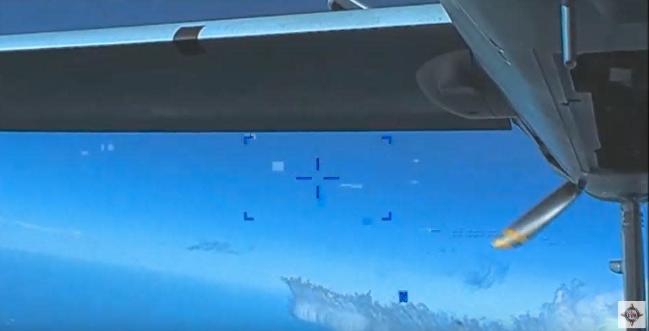 Rear view from a US MQ-9 Reaper drone after a close pass by a Russian Su-27 fighter jet.