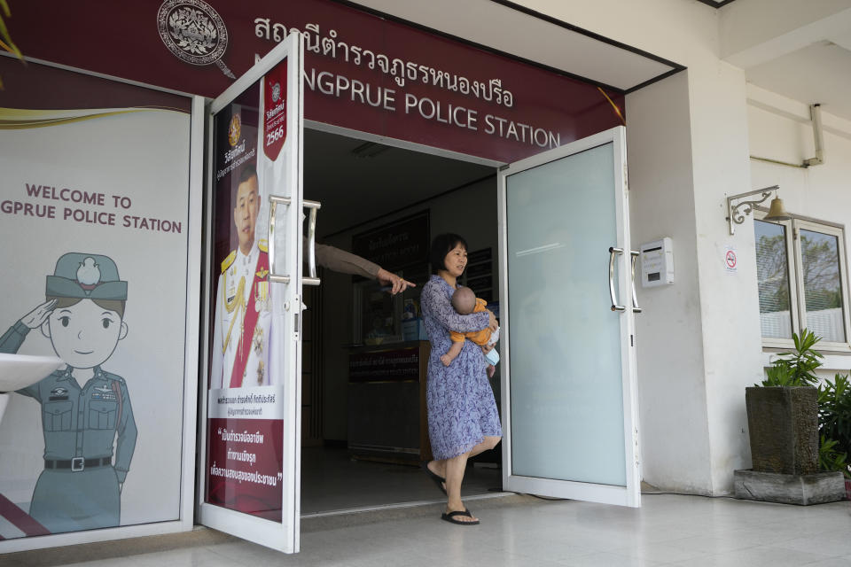 A member of the Shenzhen Holy Reformed Church, also known as the Mayflower Church, leaves with a baby from the Nongprue police station on their way to Pattaya Provincial Court in Pattaya, Thailand, Friday, March 31, 2023. More than 60 members of a Chinese Christian church have been detained in Thailand, supporters said Friday, raising fears they may be returned to their home country, where they face possible persecution. (AP Photo/Sakchai Lalit)