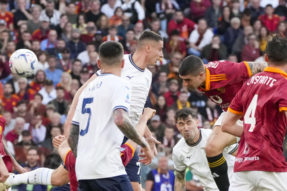 Roma's Gianluca Mancini, second right, scores his side's opening goal during a Serie A soccer match between Roma and Lazio, at Stadio Olimpico, in Rome, Italy, Saturday, April 6, 2024. (AP Photo/Gregorio Borgia)