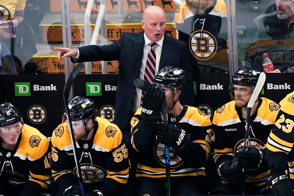 Boston Bruins head coach Jim Montgomery calls to his players during the first period of a preseason NHL hockey game against the New York Rangers in Boston, Tuesday, Sept. 27, 2022. (AP Photo/Charles Krupa)