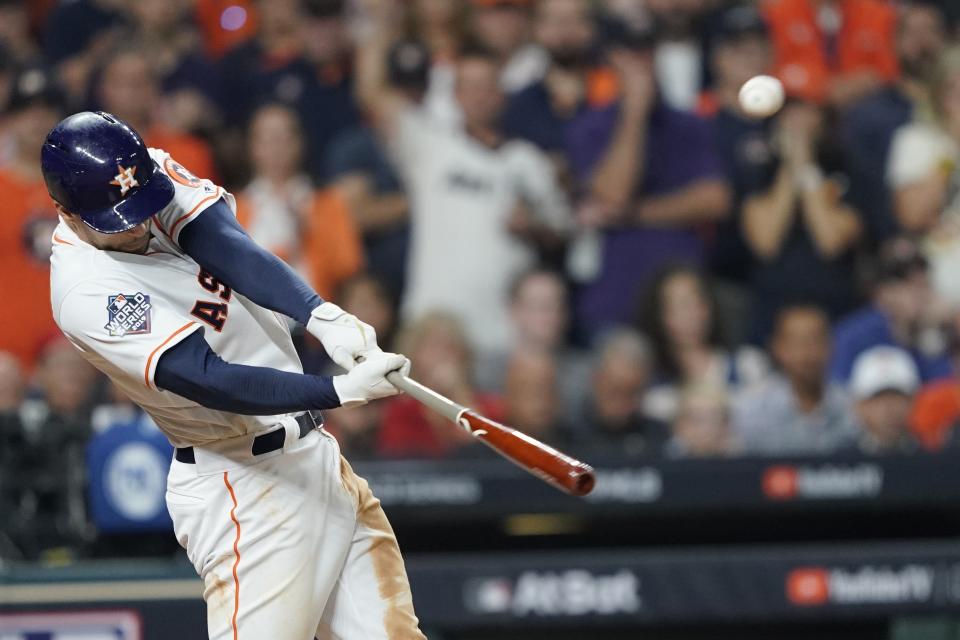 Houston Astros' George Springer hits an RBI double during the eighth inning of Game 1 of the baseball World Series against the Washington Nationals Tuesday, Oct. 22, 2019, in Houston. (AP Photo/David J. Phillip)