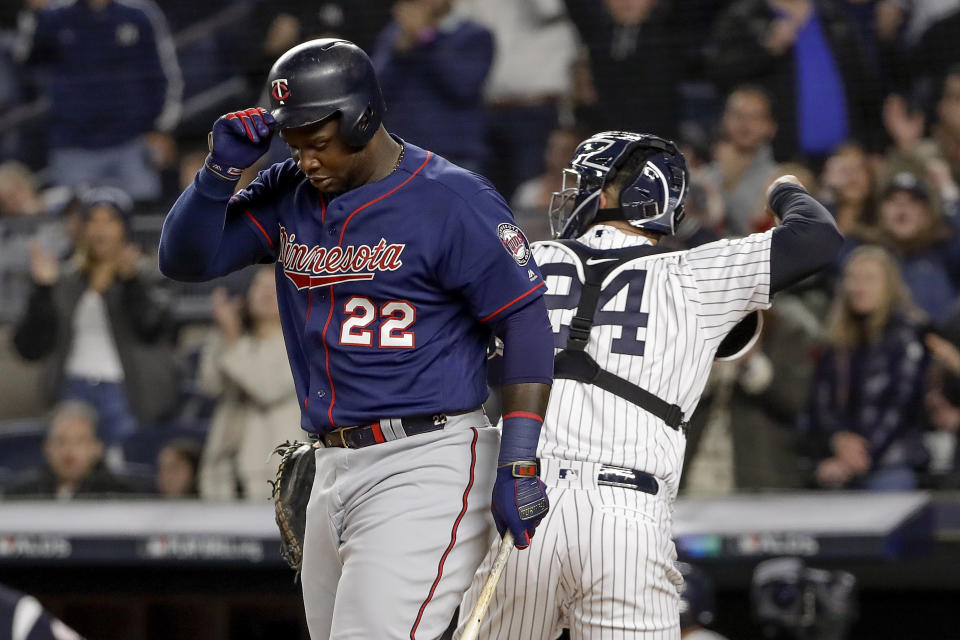 Minnesota Twins' Miguel Sano (22) pulls off his batting helmet after striking out to end the top of the first inning of Game 1 of an American League Division Series baseball game against the New York Yankees, Friday, Oct. 4, 2019, in New York. (AP Photo/Frank Franklin II)