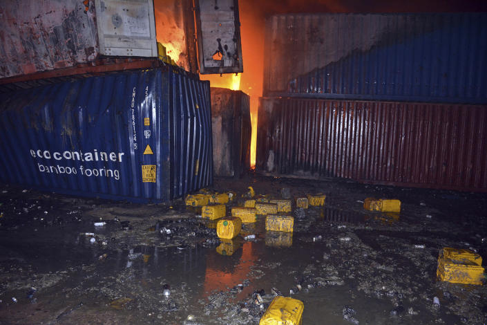 In this photo released by the Syrian official news agency SANA, flames rise from destroyed containers at the scene of a missile attack, at the seaport of the coastal city of Latakia, Syria, early Tuesday, Dec. 28, 2021. Israeli missiles fired from the Mediterranean struck the Syrian port of Latakia early Tuesday, igniting a fire in the container terminal, Syrian state media reported, in the second such attack on the vital facility this month. (SANA via AP)