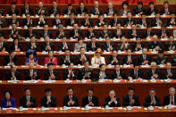 Delegates clap as Chinese President Xi Jinping delivers his speech during the opening. REUTERS/Jason Lee