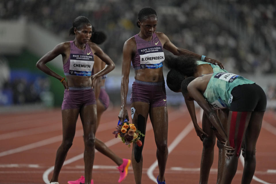 Kenya's Beatrice Chepkoech and Uganda's Peruth Chemutai, left, watch other contestants at the end of the 3000-meters women's steeplechase finals during the Diamond League event held in Suzhou in eastern China's Jiangsu province Saturday, April 27, 2024. (AP Photo/Ng Han Guan)