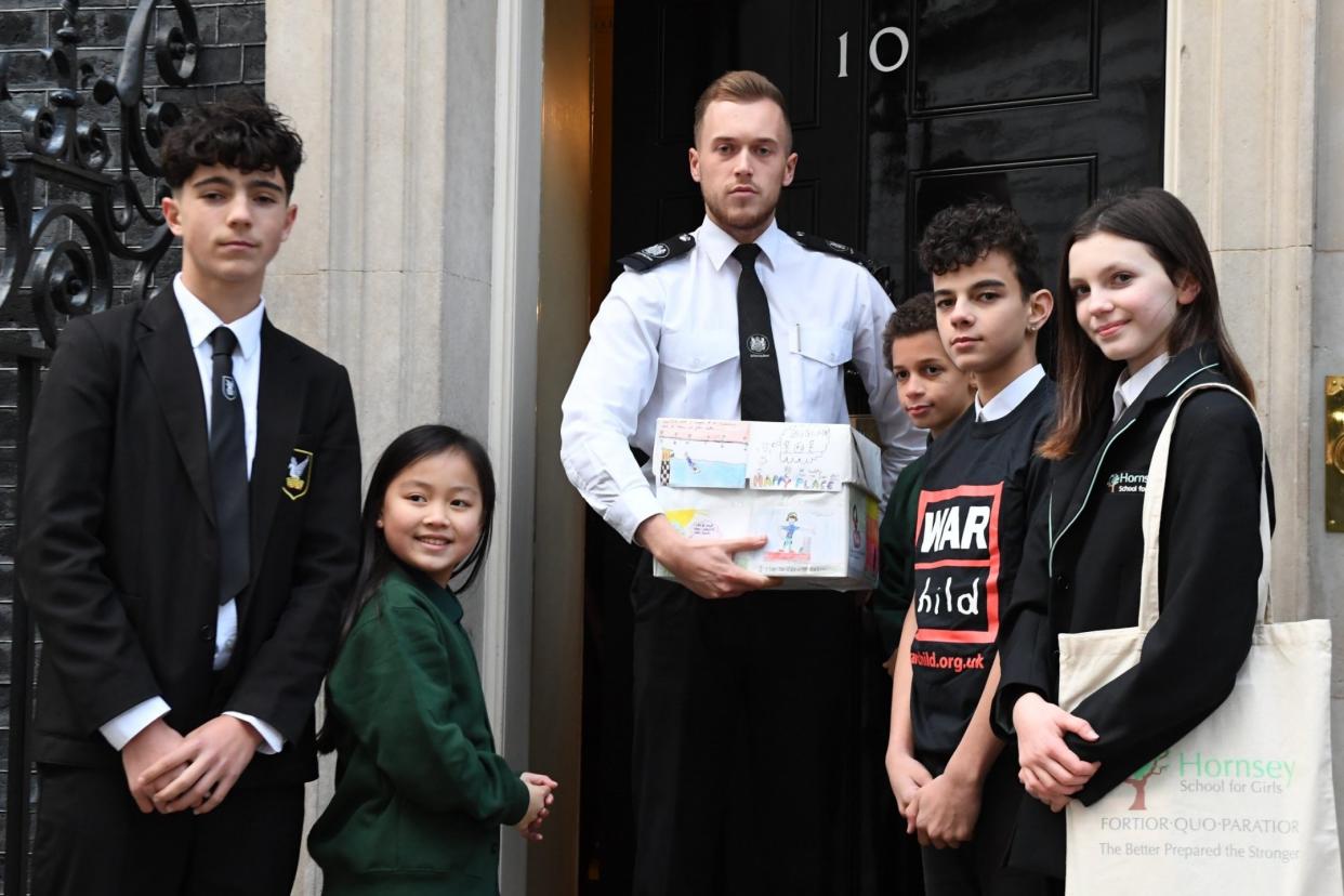 Demanding action: George Abbott, Ava Lai, Benjy Bediako, Jay Josiah and Harriet Webster hand over the petition: Jeremy Selwyn