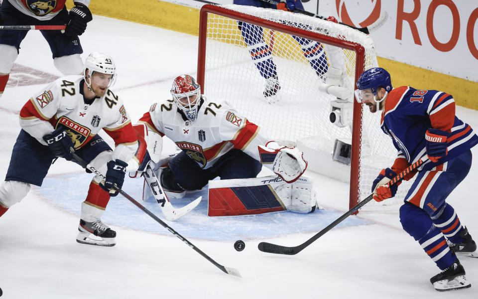 Florida Panthers' Gustav Forsling (42) and goalie Sergei Bobrovsky (72) follow the puck as Edmonton Oilers' Zach Hyman (18) tries to get to it during the third period of Game 6 of the NHL hockey Stanley Cup Final, Friday, June 21, 2024, in Edmonton, Alberta. The Oilers won 5-1 to tie the series. (Jeff McIntosh/The Canadian Press via AP)