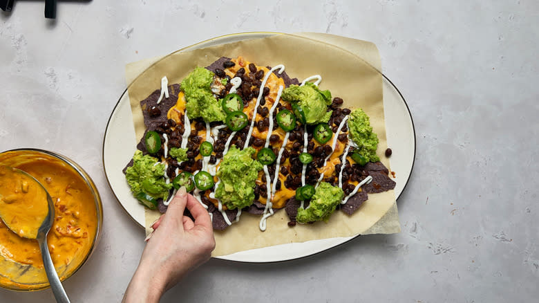 Adding jalapenos to nachos