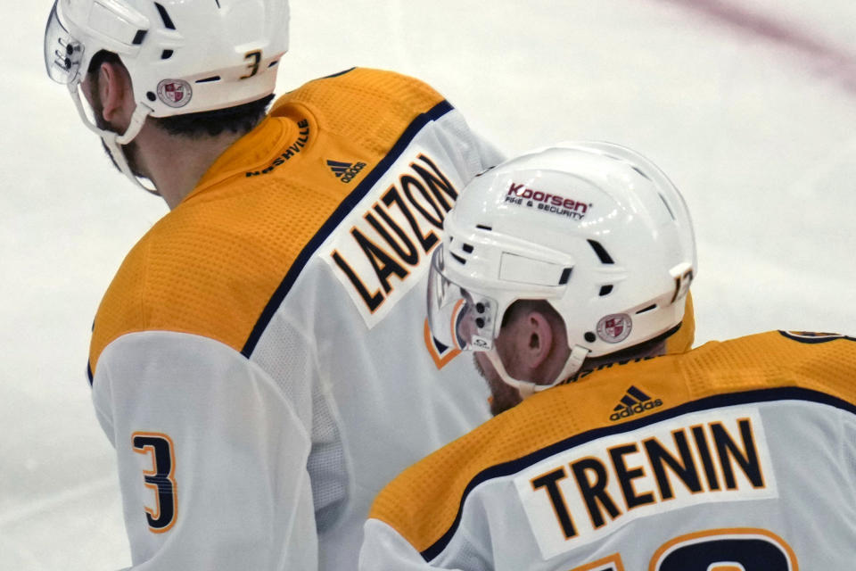 The logo of Nashville's Covenant School is displayed on the back of the helmets of Nashville Predators defenseman Jeremy Lauzon (3) and center Yakov Trenin, in honor of the school shooting victims, before the team's NHL hockey game against the Boston Bruins, Tuesday, March 28, 2023, in Boston. (AP Photo/Charles Krupa)