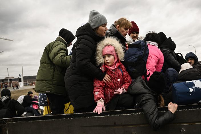 A child looks on as residents evacuate.