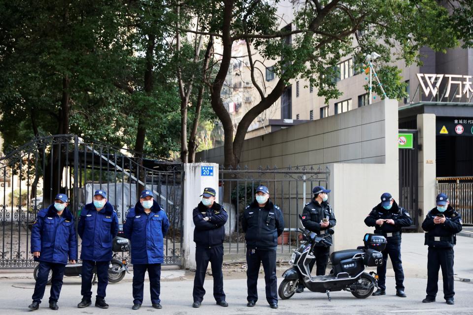 Image: WHO team members at a hospital in Wuhan (Thomas Peter / Reuters)