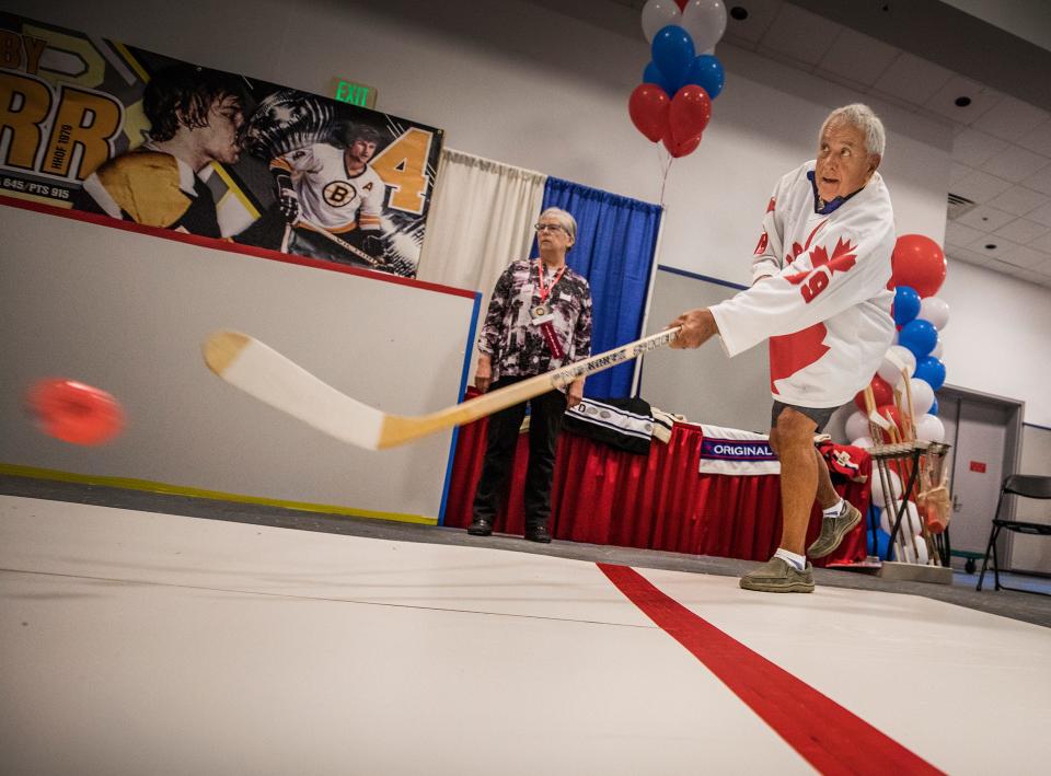 Lionel Dutrisac from Sudbury, Ontario, shoots a plastic puck in the Hockey Challenge at the Hockey Hall of Fame exhibit during the Snowbird Extravaganza in 2019.