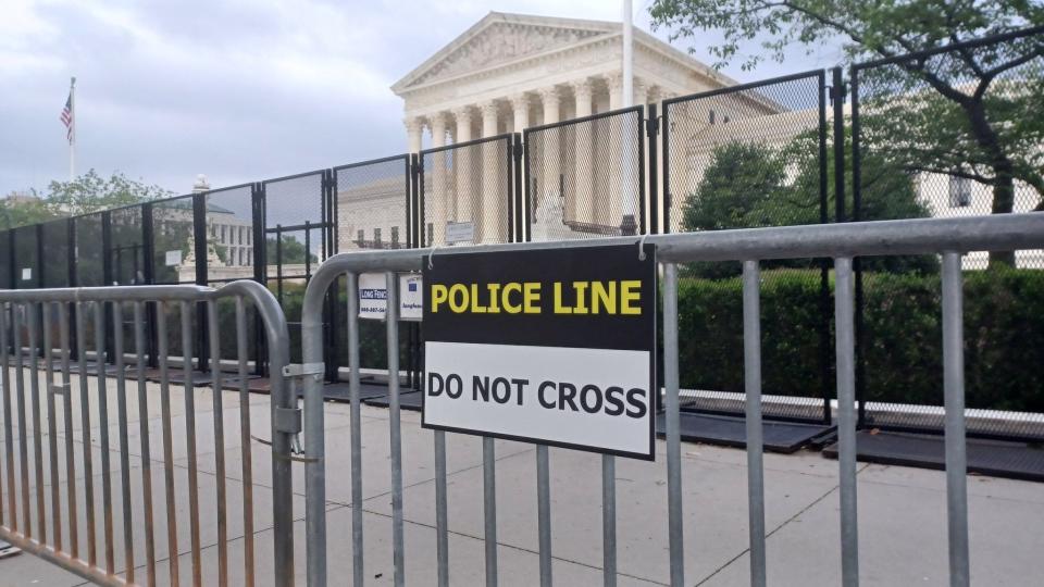 A security fence blocks access to the Supreme Court Building in Washington on Wednesday, two days before SCOTUS released an opinion overturning Roe v. Wade.