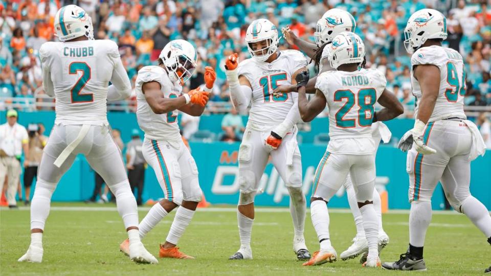 Miami Dolphins linebacker Jaelan Phillips (15) celebrates with teammates after Phillips sacks Houston Texans quarterback Kyle Allen (3) in the second half at Hard Rock Stadium in Miami Gardens on Sunday, November 27, 2022.