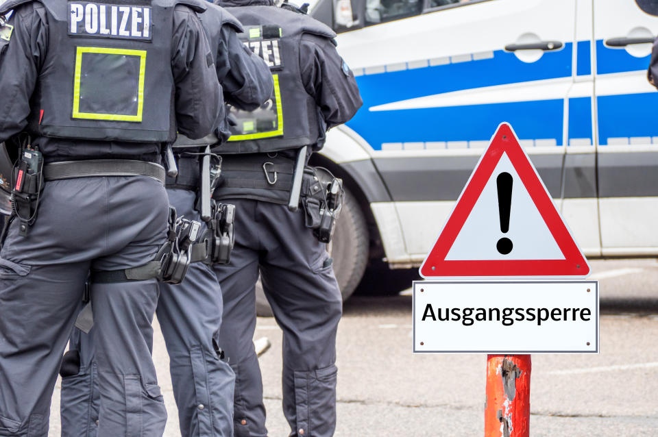 Police curfew warning sign in german background