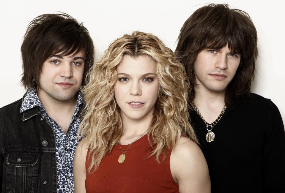 This Jan. 23, 2013, photo shows musicians Kimberly Perry, center, Neil Perry, left, and Reid Perry, from The Band Perry in Los Angeles. The band released its sophomore album "Pioneer" in April. (Photo by Matt Sayles/Invision/AP)