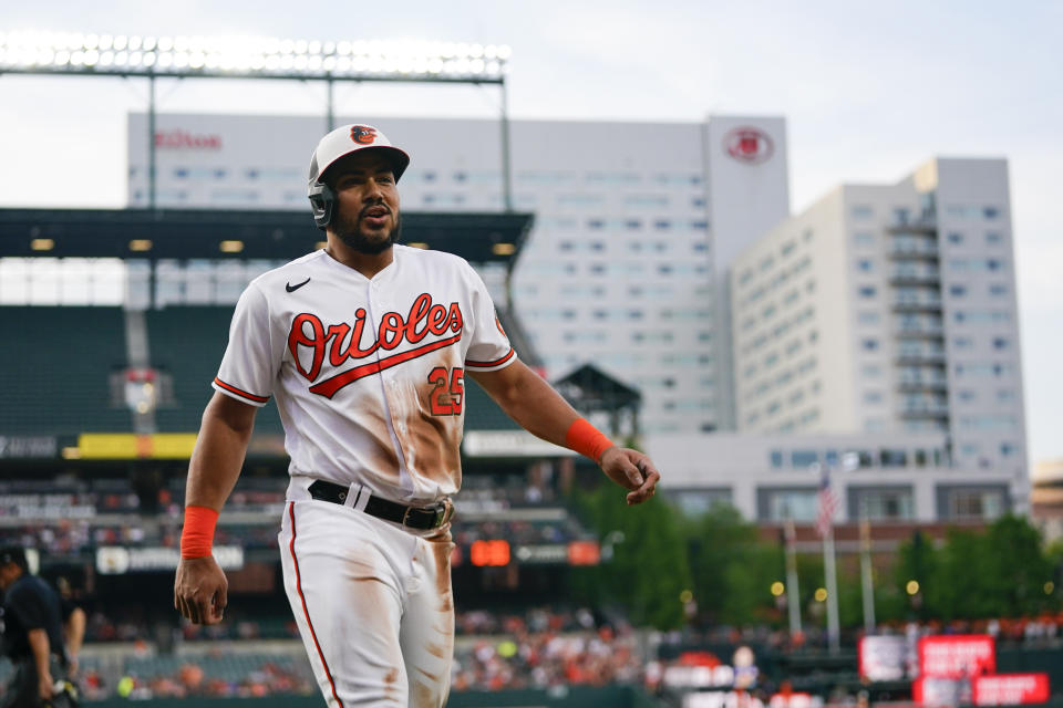 Baltimore Orioles' Anthony Santander walks to the dugout after scoring on a sacrifice fly ball by Austin Hays during the second inning of a baseball game against the Cleveland Guardians, Tuesday, May 30, 2023, in Baltimore. (AP Photo/Julio Cortez)