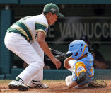 South Korea pitcher Yeong Hyeon Kim, left, covers home on a wild pitch as Honolulu, Hawaii's Zachary Won (3) scores safely from third in the third inning of the Little League World Series Championship baseball game against Honolulu, Hawaii in South Williamsport, Pa., Sunday, Aug. 26, 2018. (AP Photo/Gene J. Puskar).