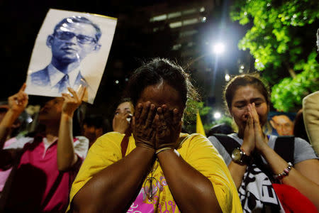 Well-wishers stand weep outside Thailand's King Bhumibol Adulyadej at the Siriraj hospital where he is residing in Bangkok, Thailand, October 13, 2016. REUTERS/Jorge Silva