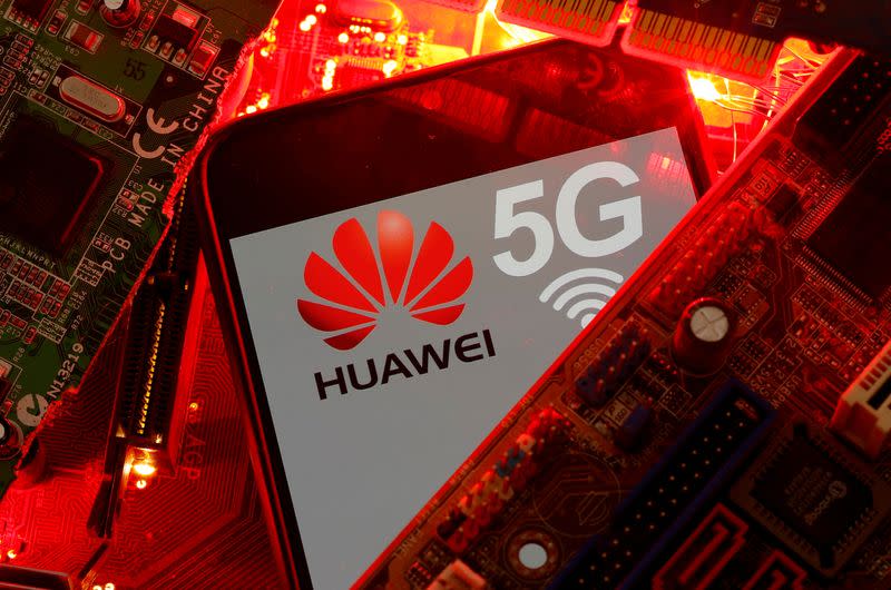 FILE PHOTO: A smartphone with the Huawei and 5G network logo is seen on a PC motherboard in this illustration