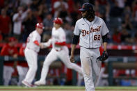 Detroit Tigers starting pitcher Jose Urena, right, looks over as Los Angeles Angels' Shohei Ohtani, center, celebrates his two-run home run with third base coach Brian Butterfield during the fifth inning of a baseball game in Anaheim, Calif., Friday, June 18, 2021. (AP Photo/Alex Gallardo)