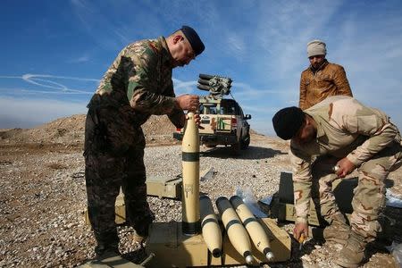 Iraqi army personnel check ammunition during clashes with Islamic State militants, north of Mosul, Iraq, December 29, 2016. REUTERS/Khalid al Mousily