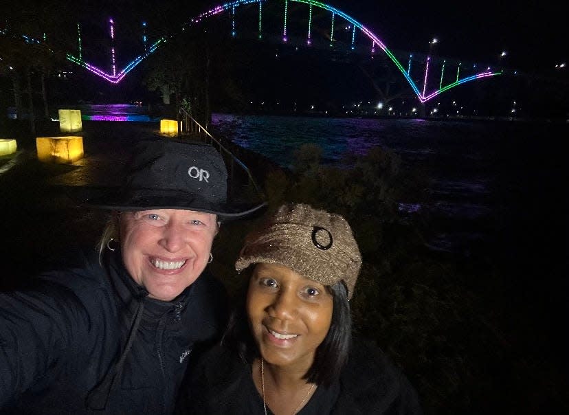 Keeshia Jones, a mentor with the organization After Breast Cancer Diagnosis, and ABCD Board member Dr. Leslie Waltke (right) smile for a photo in front of the Hoan Bridge on Metastatic Breast Cancer Awareness Day on Oct. 13.