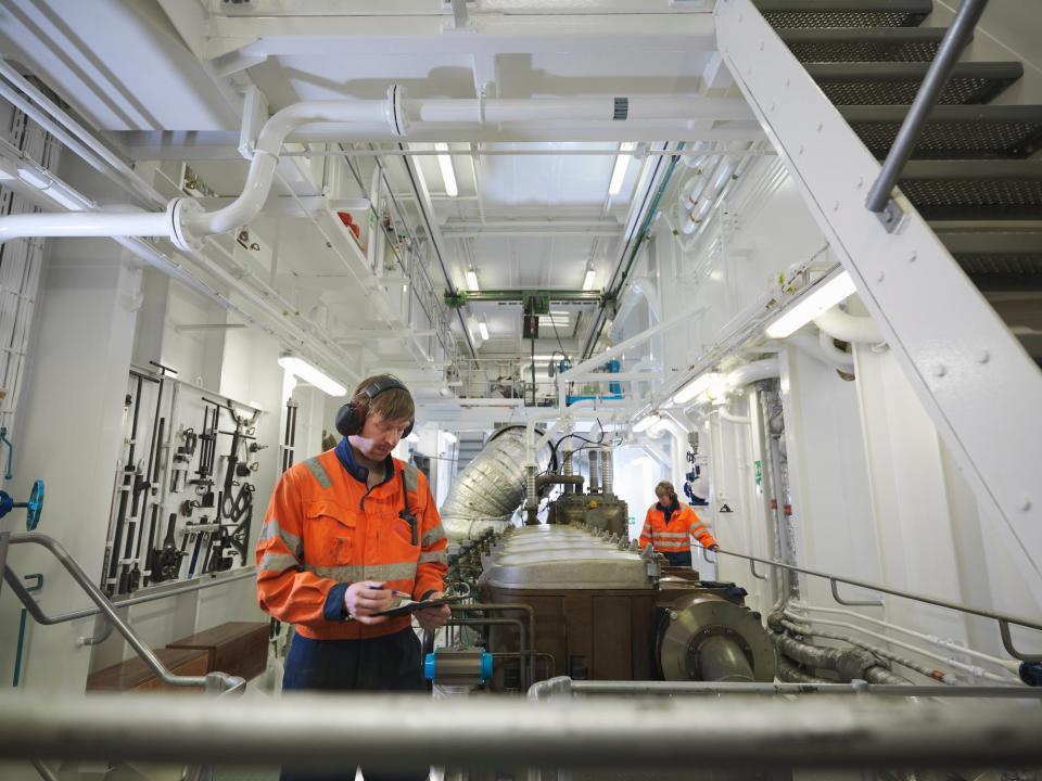 Engineers in the engine room of a ship