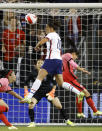 United States forward Carli Lloyd (10) heads the ball as she attempts to score against South Korea goal keeper Yoon Younggeul, back, during the second half of an international friendly soccer match in Kansas City, Kan., Thursday, Oct. 21, 2021. The match ended in a draw. (AP Photo/Colin E. Braley)