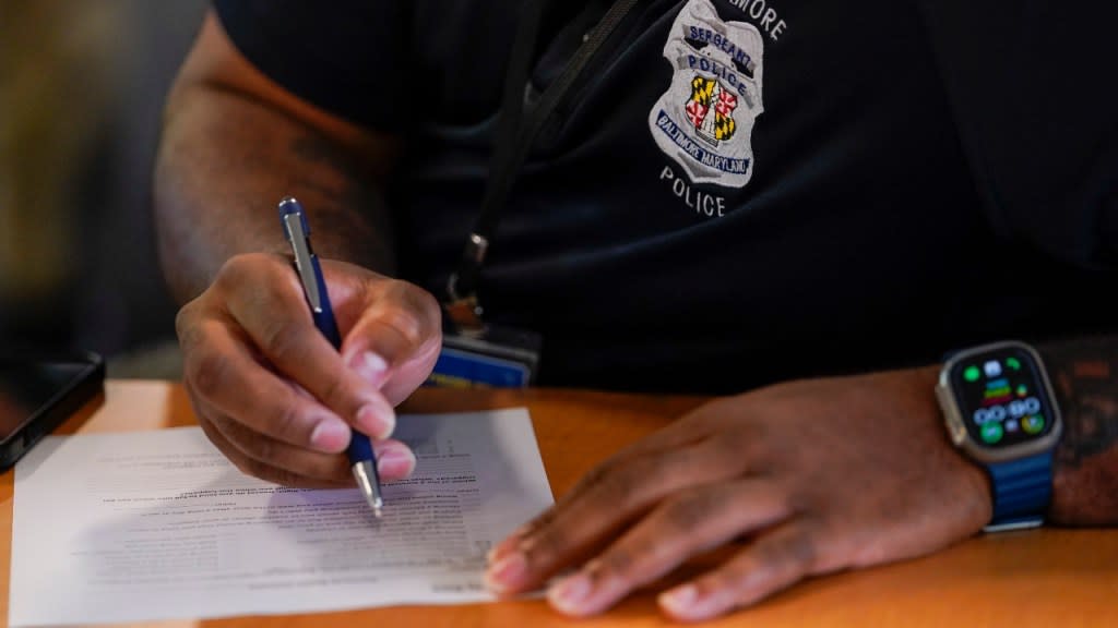 A member of the Baltimore Police Department engages in an exercise during a professional development class in September in Baltimore. The Baltimore Police Department is requiring its members to complete a program on emotional regulation that teaches them the basics of brain science by examining the relationship between thoughts, feelings and actions. (Photo: Julio Cortez/AP)