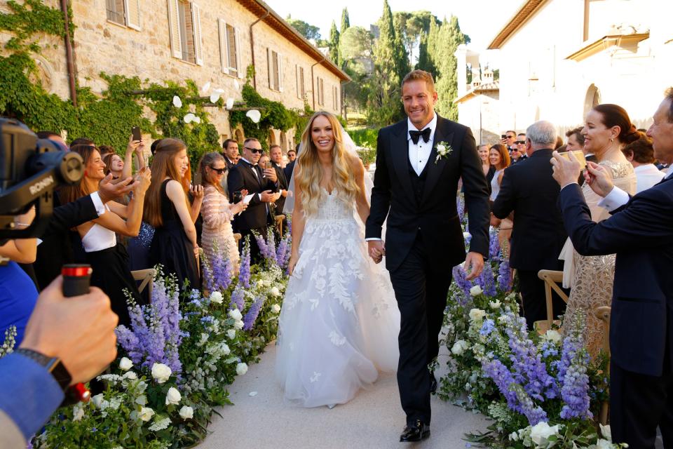 Guests through white rose petals as the newlyweds made their way back up the aisle!