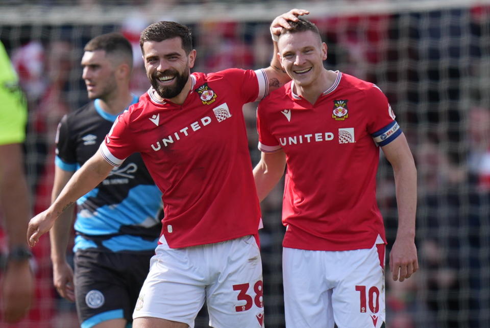 Wrexham's Paul Mullin (right) celebrates with Elliot Lee after scoring their side's fourth goal of the game during the Sky Bet League Two match at the SToK Cae Ras, Wrexham. Picture date: Saturday April 13, 2024. (Photo by Jacob King/PA Images via Getty Images)