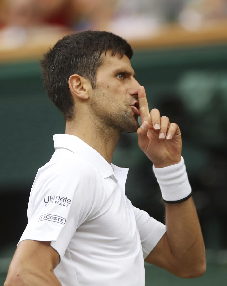 Serbia's Novak Djokovic reacts as he plays Spain's Roberto Bautista Agut in a Men's singles semifinal match on day eleven of the Wimbledon Tennis Championships in London, Friday, July 12, 2019. (Carl Recine/Pool Photo via AP)