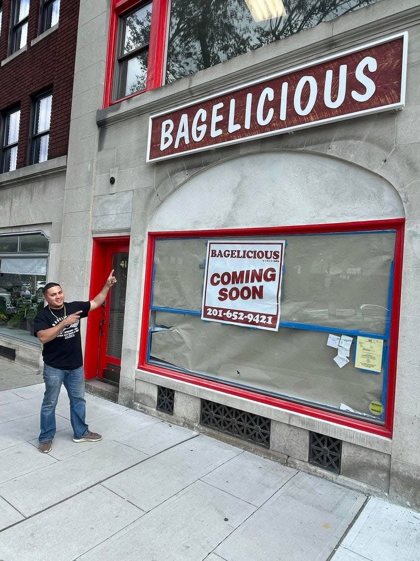 Gustavo Rosales points to sign announcing Bagelicious will reopen soon at 41 N. Broad St. in Ridgewood.  The former employee will take over management of the store previously occupied by Mango Jam.